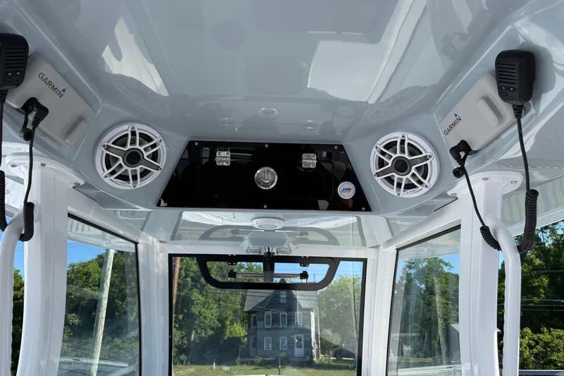 Slide: The Image of Interior view of 2026 Sportsman Open 322 Center Console with speakers and Garmin devices. - 12