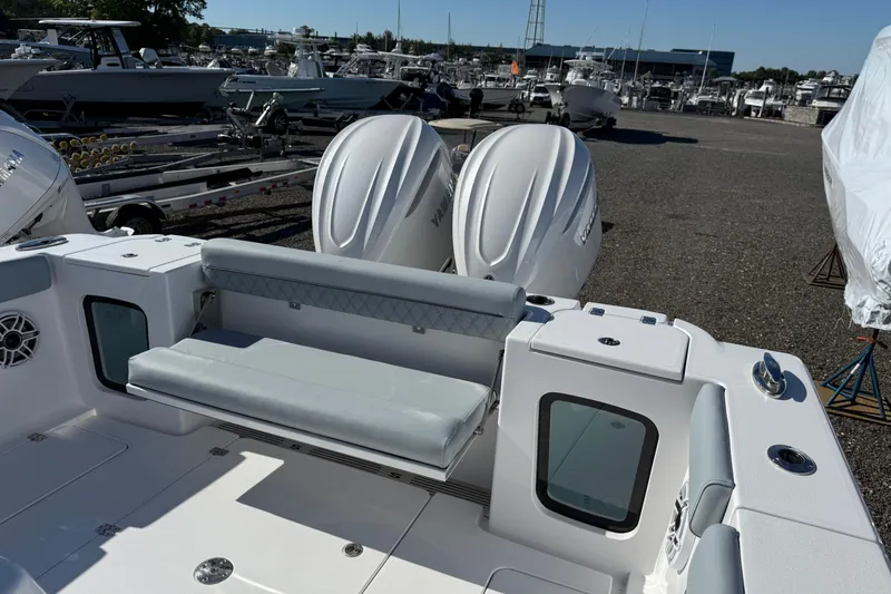 Slide: The Image of 2026 Sportsman Open 322 Center Console boat with dual engines in a marina setting. - 17