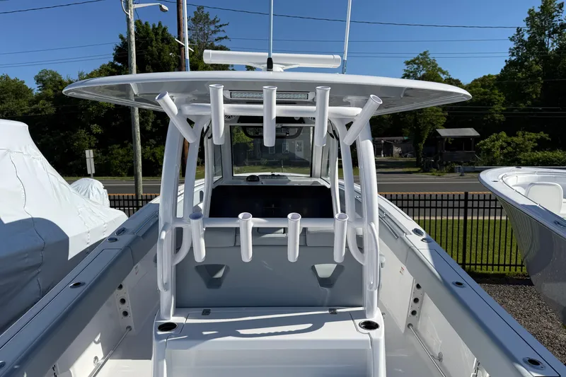 Slide: The Image of 2026 Sportsman Open 322 Center Console boat with rod holders, viewed from the rear. - 19