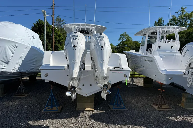 Slide: The Image of 2026 Sportsman Open 322 Center Console boat with twin 350 V6 engines on display. - 2