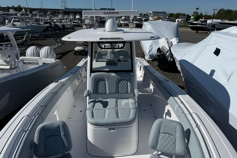 Slide: The Image of 2026 Sportsman Open 322 Center Console boat with sleek seating and Garmin equipment. - 4