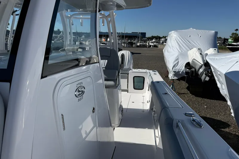 Slide: The Image of 2026 Sportsman Open 322 Center Console boat, docked with covered vessels in the background. - 9