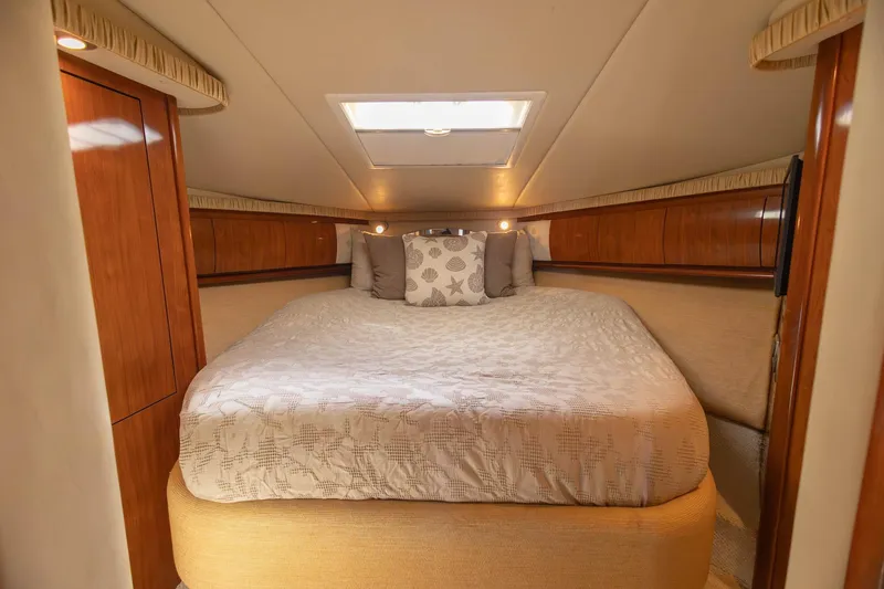 Slide: The Image of Luxurious cabin interior of 2005 Sea Ray 420 Sundancer yacht with cozy bedding. - 10