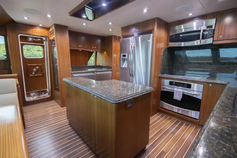 Slide: The Image of Luxurious 2009 Hargrave Enclosed Bridge yacht kitchen with modern appliances and elegant wood finishes. - 21