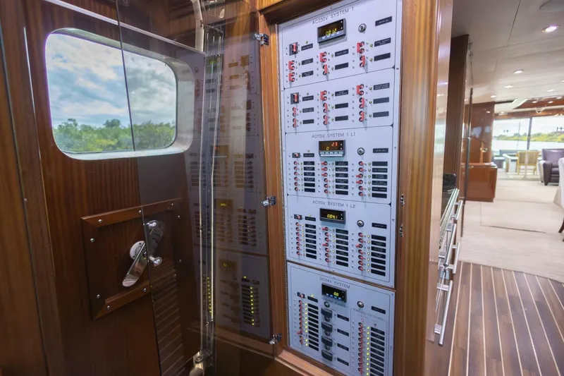 Slide: The Image of Electrical control panel on 2009 Hargrave Enclosed Bridge yacht, featuring wood paneling and modern interior. - 25
