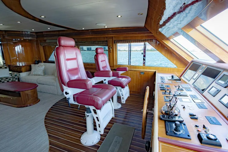 Slide: The Image of Luxurious 2009 Hargrave Enclosed Bridge yacht interior with red captain chairs and control panel. - 27