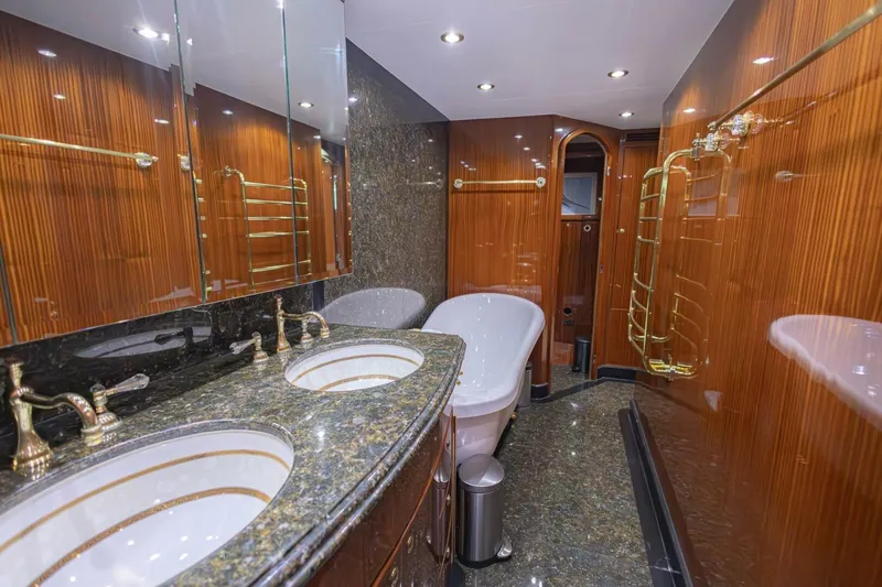 Slide: The Image of Luxurious bathroom in 2009 Hargrave Enclosed Bridge yacht with dual sinks and elegant wood paneling. - 38