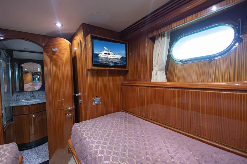 Slide: The Image of Luxurious 2009 Hargrave Enclosed Bridge yacht cabin with wood paneling and porthole window. - 50