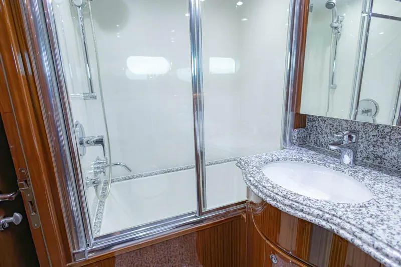 Slide: The Image of Luxurious bathroom in 2009 Hargrave Enclosed Bridge yacht with granite countertop and glass shower. - 52