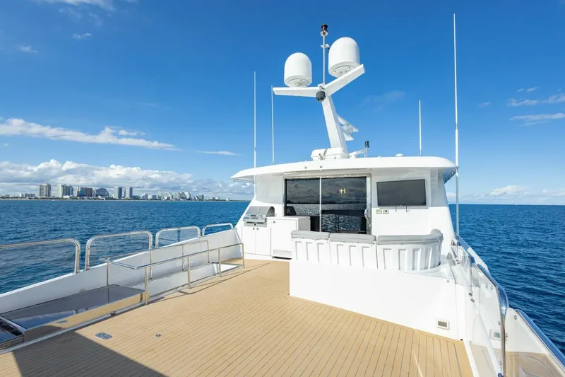 Slide: The Image of Luxurious 2009 Hargrave Enclosed Bridge yacht cruising on open sea with city skyline backdrop. - 56