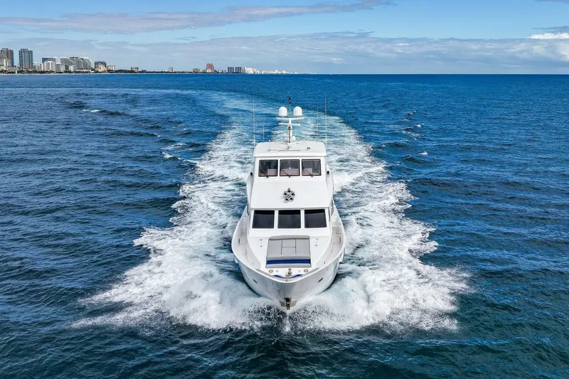 Slide: The Image of 2009 Hargrave Enclosed Bridge yacht cruising on open ocean near city skyline. - 6