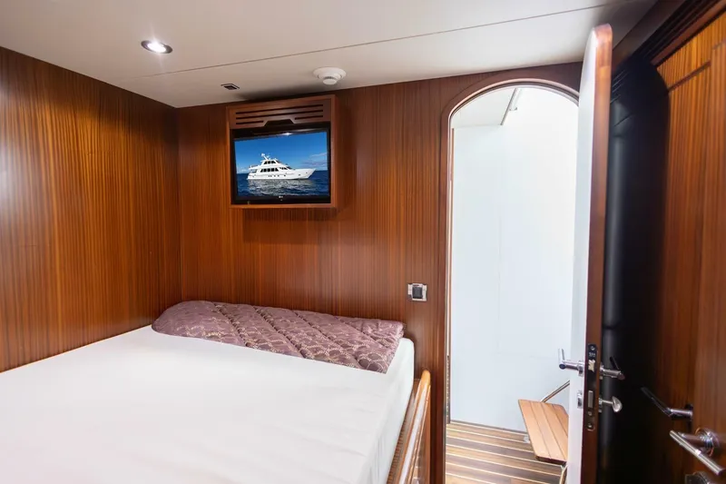 Slide: The Image of Luxurious cabin interior of 2009 Hargrave Enclosed Bridge yacht with wood paneling and TV. - 80