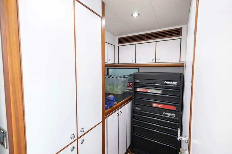Slide: The Image of 2009 Hargrave Enclosed Bridge yacht interior with tool storage and white cabinetry. - 82