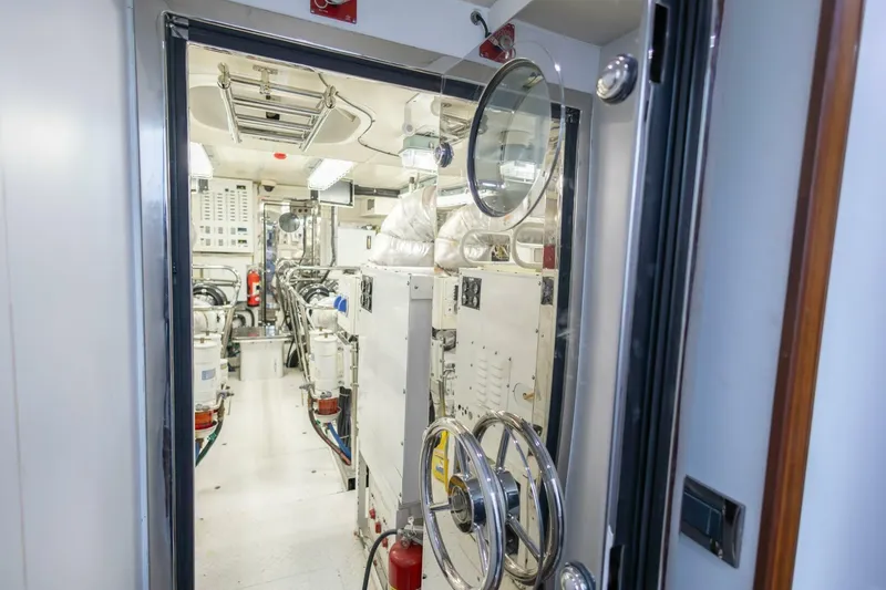 Slide: The Image of Engine room of 2009 Hargrave Enclosed Bridge yacht, featuring modern equipment and controls. - 83