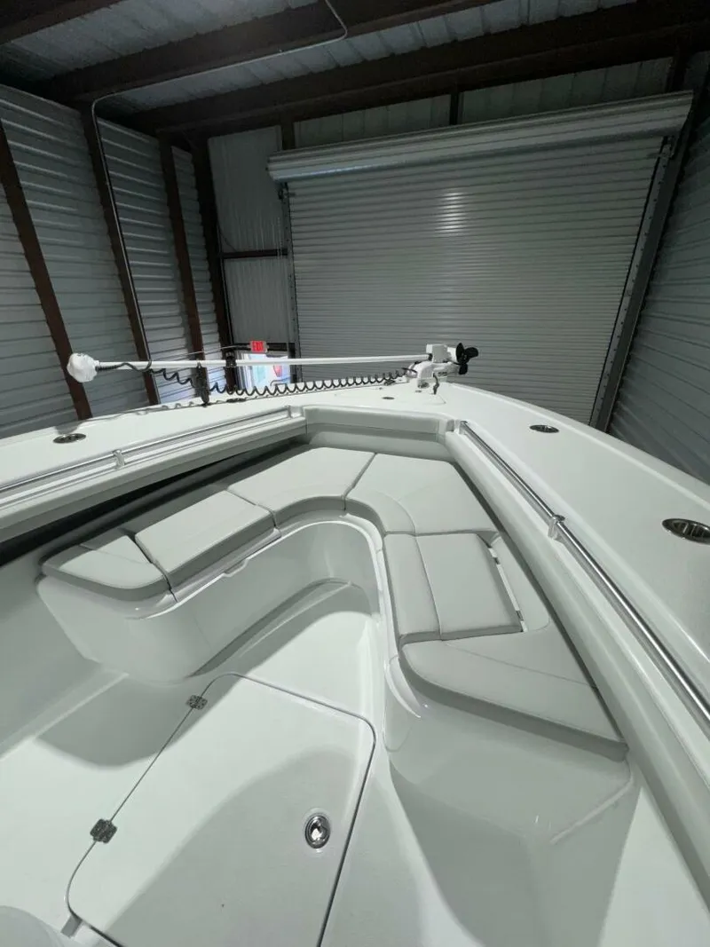 Slide: The Image of 2024 Yellowfin 36 boat interior with sleek seating and storage in a garage setting. - 11