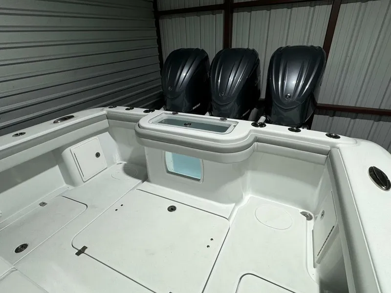 Slide: The Image of 2024 Yellowfin 36 boat with triple outboard engines in a storage facility. - 15