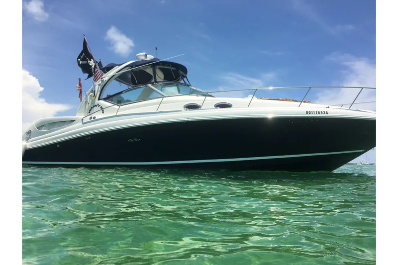 The Image of 2006 Sea Ray 340 Sundancer yacht on clear water under blue sky. - 0