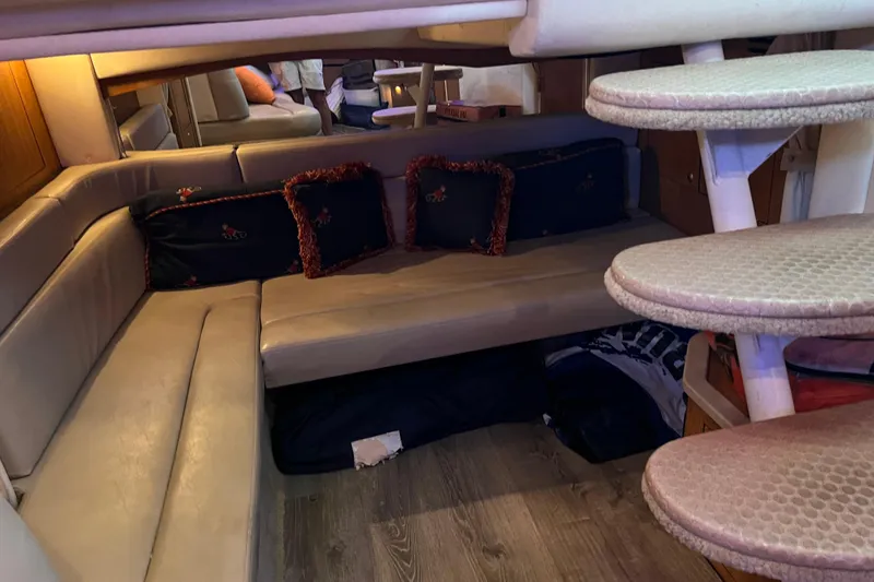 Slide: The Image of Interior of 2006 Sea Ray 340 Sundancer with cozy seating and decorative pillows. - 11