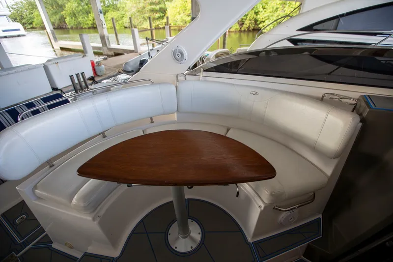 Slide: The Image of 2008 Regal 38 yacht interior with curved seating and wooden table. - 12