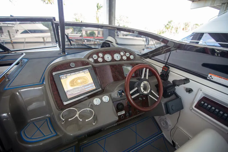 Slide: The Image of 2008 Regal 38 boat dashboard with steering wheel, gauges, and navigation screen. - 13