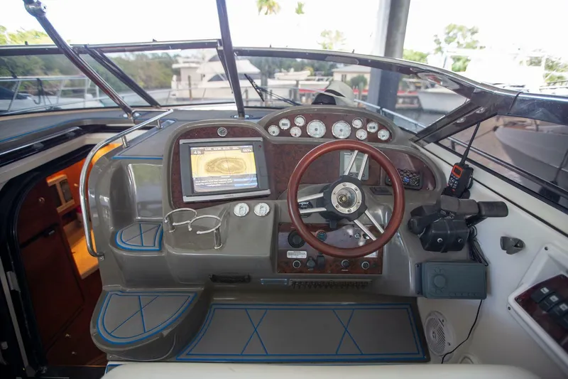 Slide: The Image of Cockpit of 2008 Regal 38 boat with steering wheel, gauges, and navigation screen. - 14