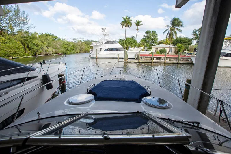 Slide: The Image of 2008 Regal 38 yacht docked in a scenic marina with palm trees and boats. - 15