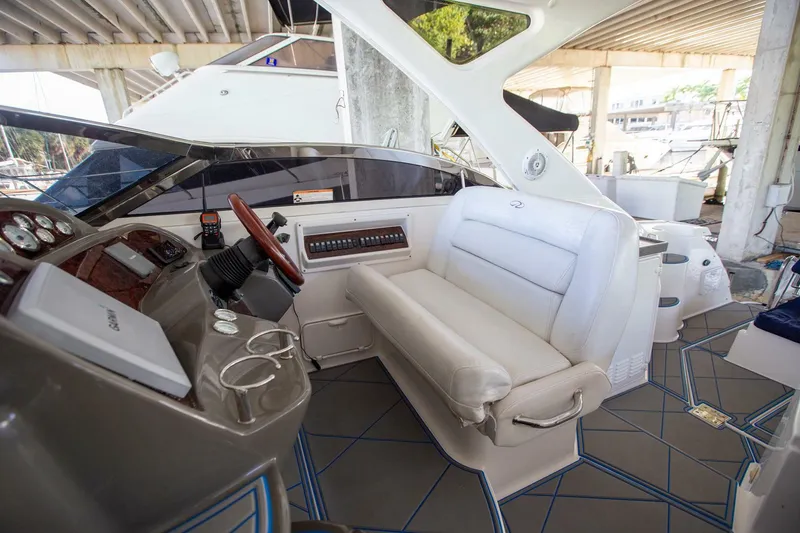 Slide: The Image of 2008 Regal 38 yacht interior with helm, white seating, and modern controls. - 17
