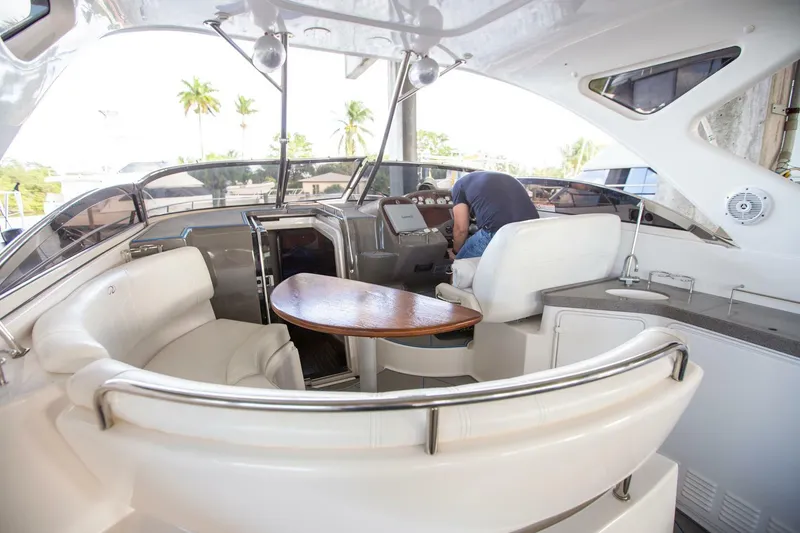 Slide: The Image of Interior of a 2008 Regal 38 yacht with seating and control panel. - 25