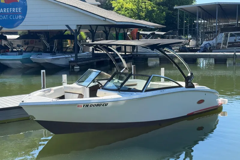 The Image of 2018 Cobalt CS22 boat docked at marina with canopy and sleek design. - 1