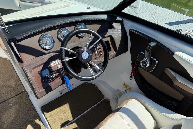 Slide: The Image of 2018 Cobalt CS22 boat dashboard with steering wheel and control panel. - 10