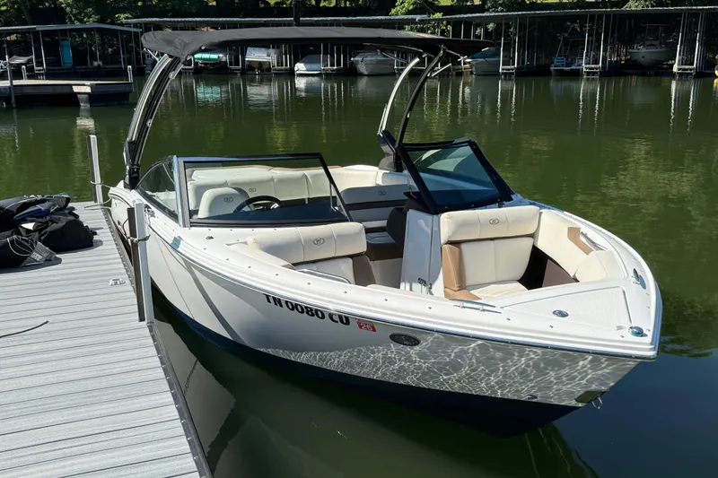 Slide: The Image of 2018 Cobalt CS22 boat docked on calm water with canopy. - 3