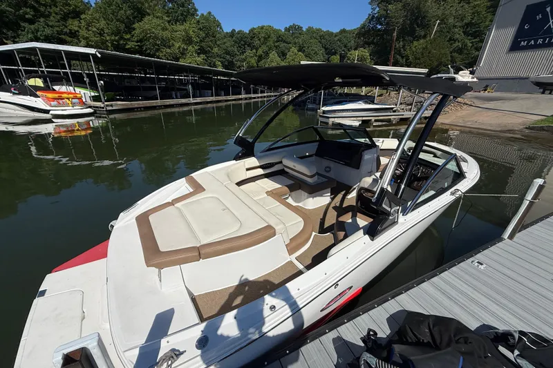 Slide: The Image of 2018 Cobalt CS22 boat docked at marina, featuring spacious seating and sleek design. - 4