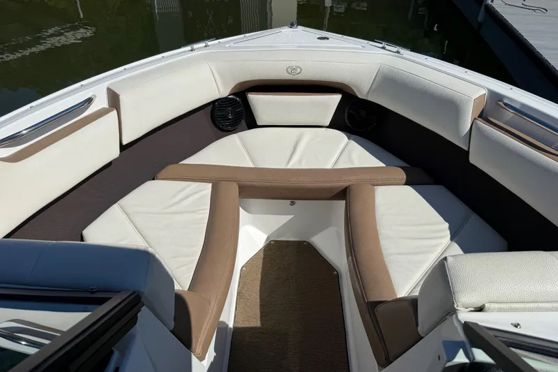 Slide: The Image of Bow seating area of a 2018 Cobalt CS22 boat with white and brown upholstery. - 9