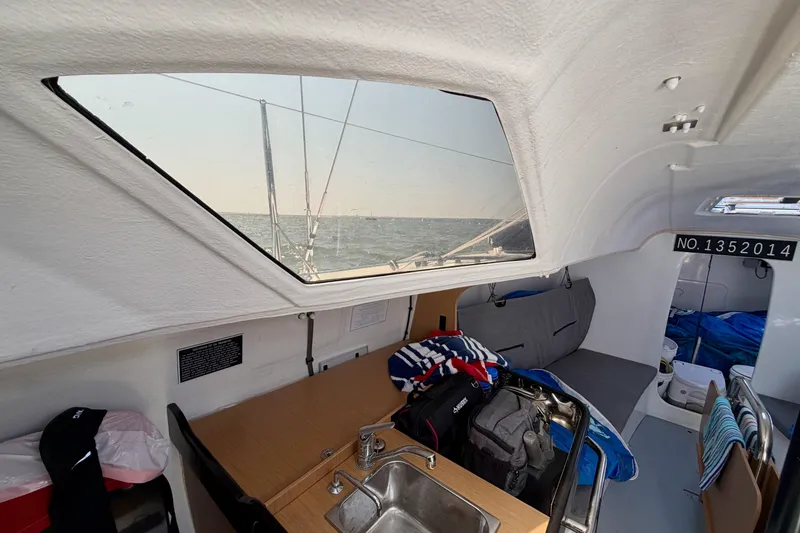 Slide: The Image of Interior view of 2020 Jeanneau Sun Fast 3300 sailboat with ocean visible through window. - 53