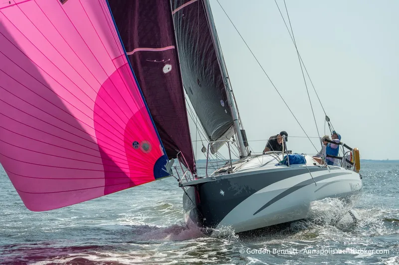 Slide: The Image of 2020 Jeanneau Sun Fast 3300 sailing with vibrant pink spinnaker on open water. - 2