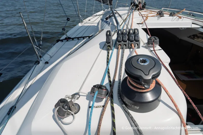 Slide: The Image of 2020 Jeanneau Sun Fast 3300 sailboat deck with winches and ropes in use. - 27