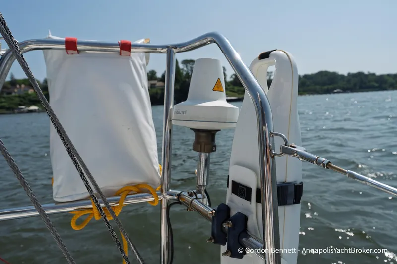 Slide: The Image of 2020 Jeanneau Sun Fast 3300 yacht railing with equipment, overlooking calm waters. - 40