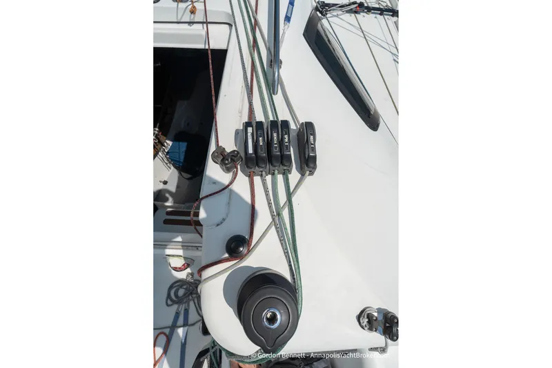 Slide: The Image of Deck rigging of a 2020 Jeanneau Sun Fast 3300 sailboat, featuring ropes and winches. - 25