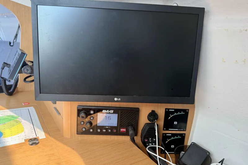 Slide: The Image of Navigation station on 2020 Jeanneau Sun Fast 3300 sailboat with electronics and chart. - 55