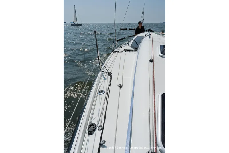Slide: The Image of 2020 Jeanneau Sun Fast 3300 sailing on open water, with visible deck and rigging. - 24