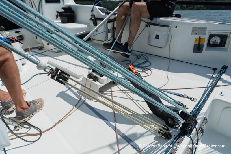 Slide: The Image of 2020 Jeanneau Sun Fast 3300 sailboat cockpit with rigging and crew members. - 33
