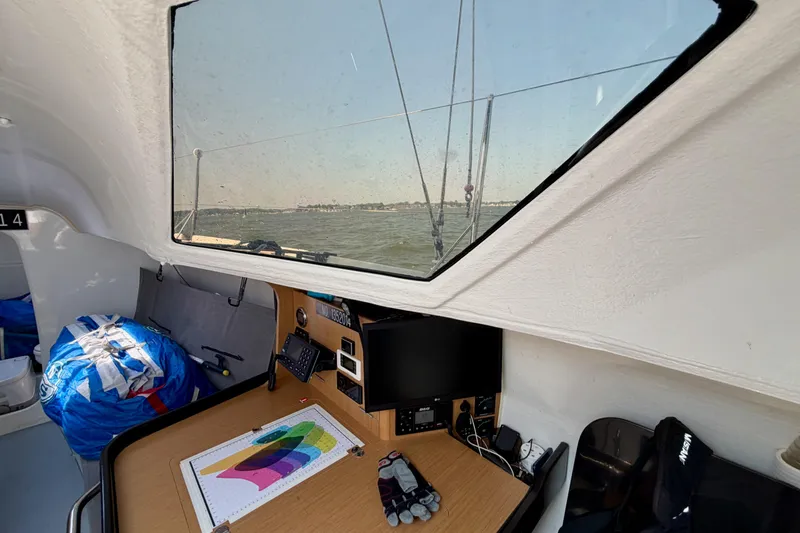 Slide: The Image of Interior view of 2020 Jeanneau Sun Fast 3300 sailboat with navigation station and sea view. - 52