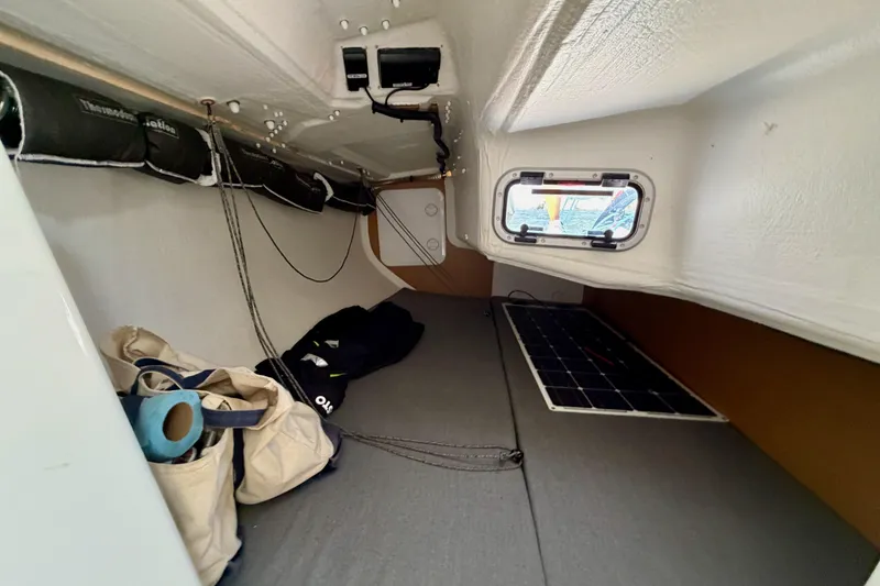 Slide: The Image of Interior cabin of 2020 Jeanneau Sun Fast 3300 sailboat, featuring storage and a small window. - 47