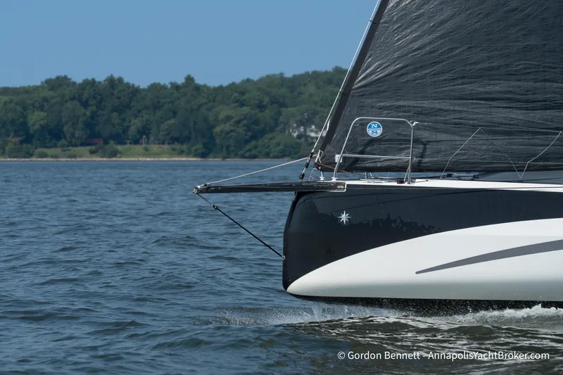 Slide: The Image of 2020 Jeanneau Sun Fast 3300 sailing on a calm lake with forested shoreline. - 8