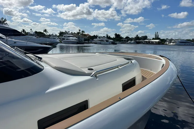 Slide: The Image of 2025 Solaris Power 44 Open yacht docked in a serene marina under a partly cloudy sky. - 12