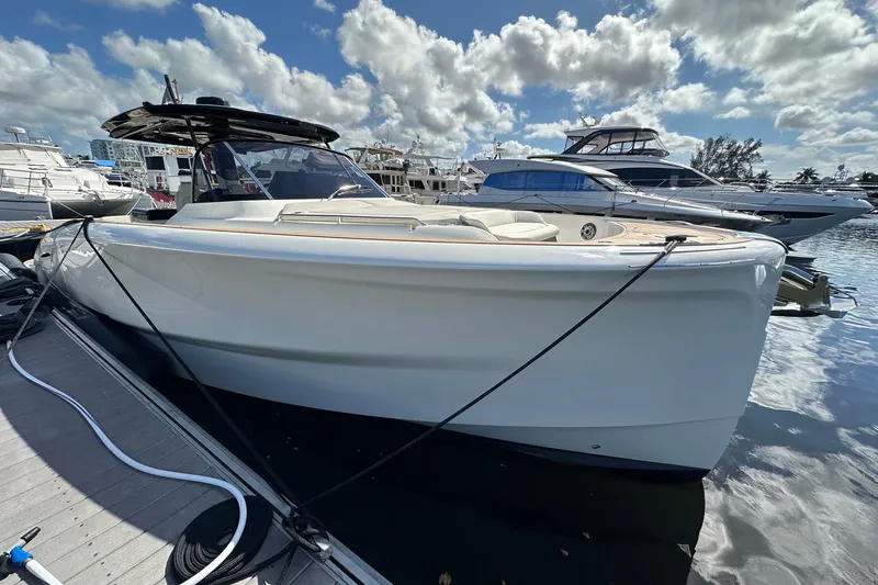 Slide: The Image of 2025 Solaris Power 44 Open yacht docked under a partly cloudy sky. - 13