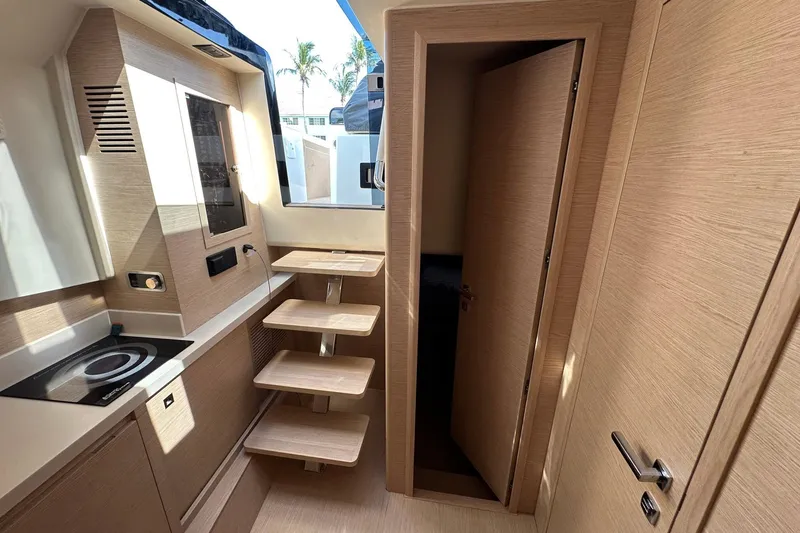 Slide: The Image of Interior of 2025 Solaris Power 44 Open yacht, featuring modern kitchen and wooden stairs. - 17