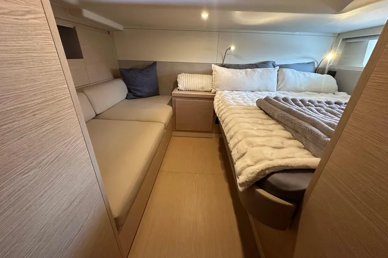Slide: The Image of Luxurious cabin interior of 2025 Solaris Power 44 Open yacht, featuring cozy bedding and seating. - 18