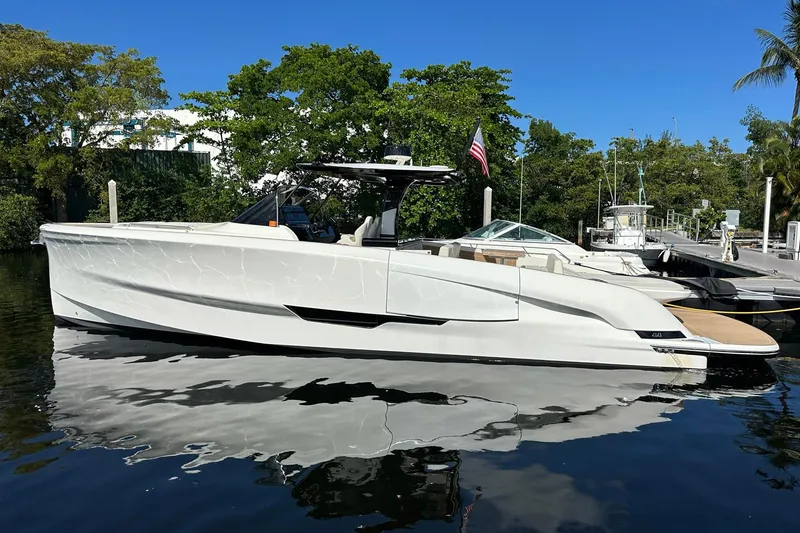 Slide: The Image of 2025 Solaris Power 44 Open yacht docked, sleek design, reflecting on calm water. - 2