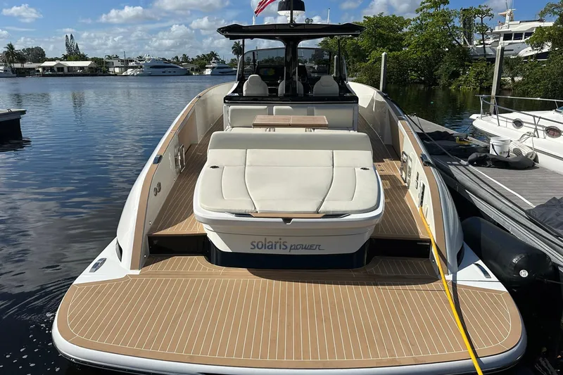 Slide: The Image of 2025 Solaris Power 44 Open yacht docked, featuring spacious deck and luxurious seating. - 5